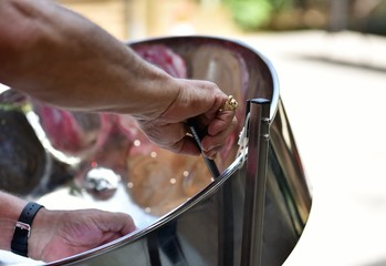 Caribbean Steel pan drum player with sticks