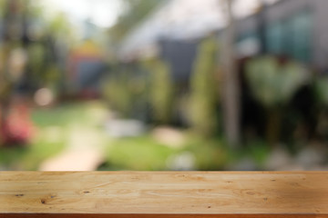 Empty dark wooden table in front of abstract blurred bokeh background of restaurant . can be used for display or montage your products.Mock up for space.