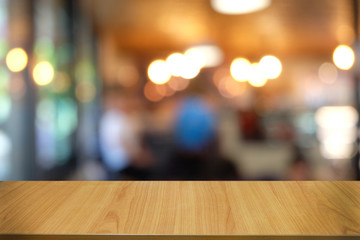 Empty dark wooden table in front of abstract blurred bokeh background of restaurant . can be used for display or montage your products.Mock up for space.