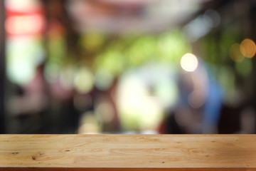 Empty dark wooden table in front of abstract blurred bokeh background of restaurant . can be used for display or montage your products.Mock up for space.