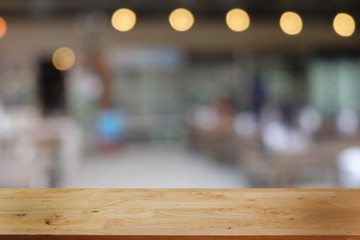 Empty dark wooden table in front of abstract blurred bokeh background of restaurant . can be used for display or montage your products.Mock up for space.