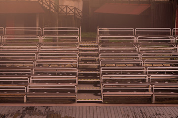 Empty benches on tribune with scene background