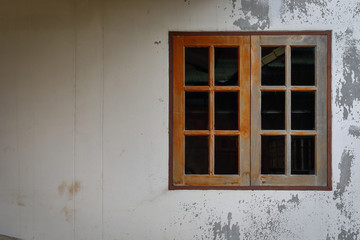 Fototapeta premium old glass window with wooden frame on weathered wall