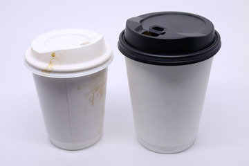 dirty brown stain on take away cup for hot coffee drink, paper mug on white background
