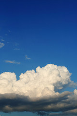 large rain cloud on clear blue sky background