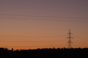 High voltage tower with silhouette sky sunset background