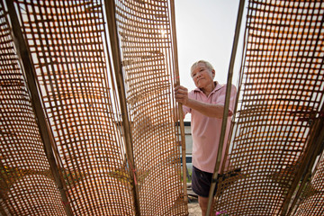 Thai men of Vietnamese descent making drying Vietnamese Rice Paper,Nongkhai,Thailand