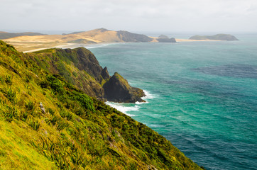 Coastline view from Cape Reinga with blue sky and white clouds above, Northland, New Zealand