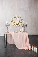 Wedding ceremony decoration. Decoration of wedding table with tender pink textile. Wedding decorated area.