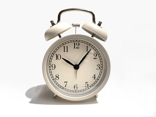 White retro alarm clock on white background