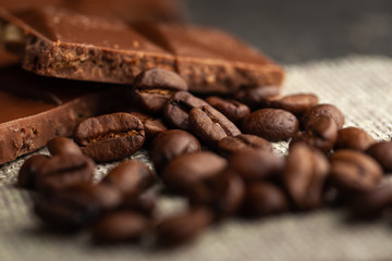Coffee beans with and dark chocolate glaze on cloth background