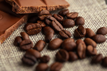 Coffee beans with and dark chocolate glaze on cloth background