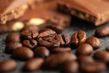 Coffee beans and dark chocolate glaze on gray background