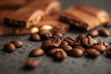 Coffee beans and dark chocolate glaze on gray background
