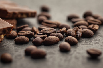 Coffee beans and dark chocolate glaze on gray background