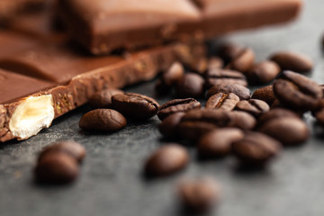 Coffee beans and dark chocolate glaze on gray background