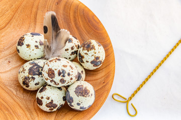 Quail eggs in a wooden bowl
