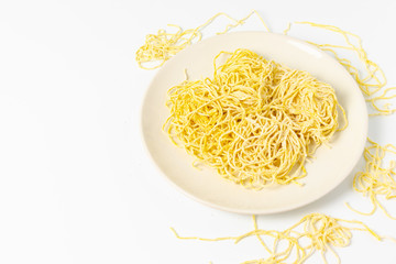 Yellow noodles are placed on a white background