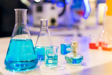 Close up of beautiful blue colorful chemistry liquid in various laboratory flask for science