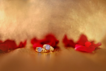 Golden engagement ring with red rose flower