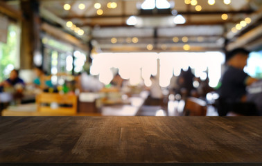 Empty dark wooden table in front of abstract blurred bokeh background of restaurant . can be used for display or montage your products.Mock up for space.