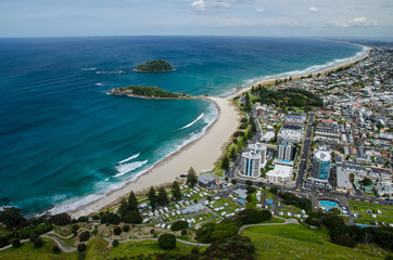 Fototapeta premium View of the coastline from the top of Mount Manganui with blue sky above, Tauranga, North Island, New Zealand