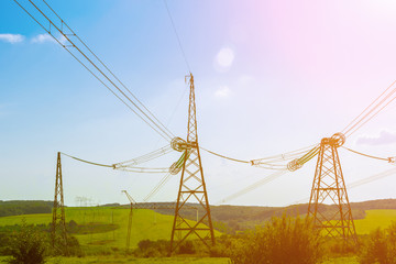 power line close-up on a blue sky background using toning. Energy and electricity concept