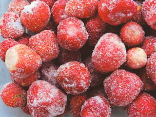 Frozen berries.Top view. Frozen delicious Strawberries, closeup. Assorted frozen berries background. Strawberries on blue background, copy space. Strawberry. Fresh organic berries macro.