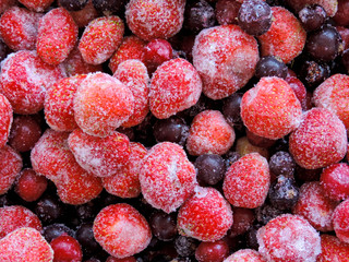 Frozen berries.Top view. Frozen delicious berries on blue background, closeup. Assorted frozen berries background. Raspberries, black currant and strawberries on blue background, copy space.