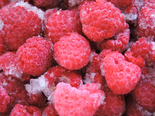 Fresh and sweet raspberries background. Frozen berries.Top view. Frozen delicious berries  background, closeup. Assorted frozen berries background. Raspberries background, copy space.