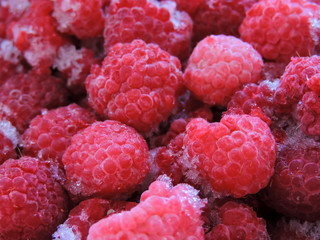 Fresh and sweet raspberries background. Frozen berries.Top view. Frozen delicious berries  background, closeup. Assorted frozen berries background. Raspberries background, copy space.