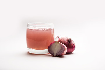 Medicinal Onion juice/syrup in a glass with raw onions. selective focus