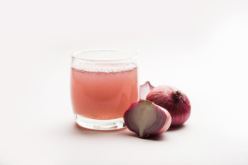 Medicinal Onion juice/syrup in a glass with raw onions. selective focus