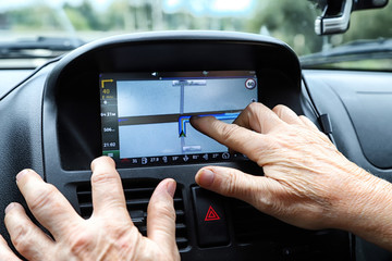 Close up woman hand press navigation screen in the car