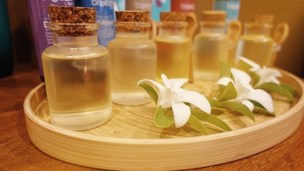 Composition of spa wellness products, bottles with massage oils with flower 