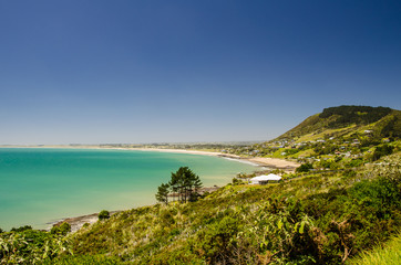 View from the Shipwreck Bay to the Ninety Mine Beach with blue sky above, Northland, New Zealand