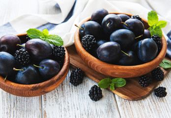 Bowls with fresh plums