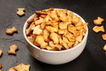 Goldfish crackers in a bowl on a black background