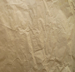 Beige crumpled packaging paper for background. Textured abstract crumpled craft wrapping brown paper background, retro style.