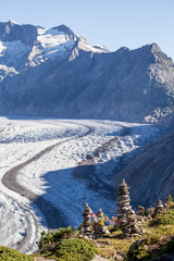 Glacier in the alps with buddhistic flags and stone tower