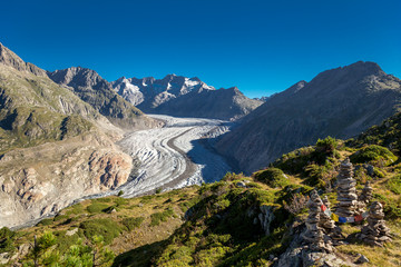 Glacier in the alps with buddhistic flags and stone tower