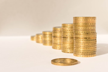 Stacks of coins on a light background. Business concept and growth of capital.