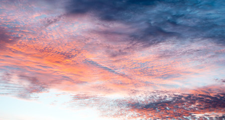 Colorful clouds in the sky with bright pinks, blues, reds, oranges over the outback in Australia - painterly