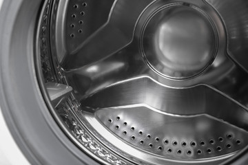 Modern washing machine with empty drum, closeup