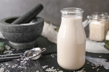 Bottle of healthy rice milk on table