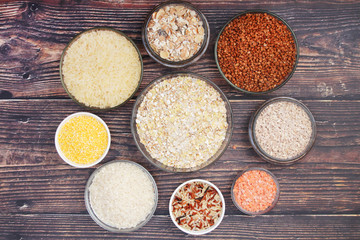 A set of bowls filled with different seeds: buckwheat, rise, corn and oatmeal