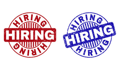 Grunge HIRING round stamp seals isolated on a white background. Round seals with grunge texture in red and blue colors. Vector rubber overlay of HIRING text inside circle form with stripes.