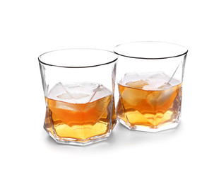 Glasses of whiskey on white background