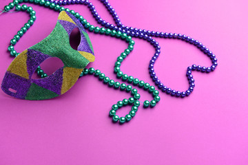 Festive mask with beads on color background © Pixel-Shot