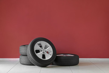 Obraz na płótnie Canvas Car tires near color wall